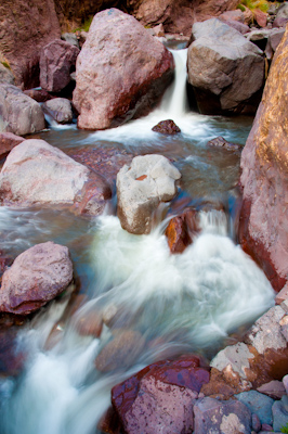 Stream flowing through boulders